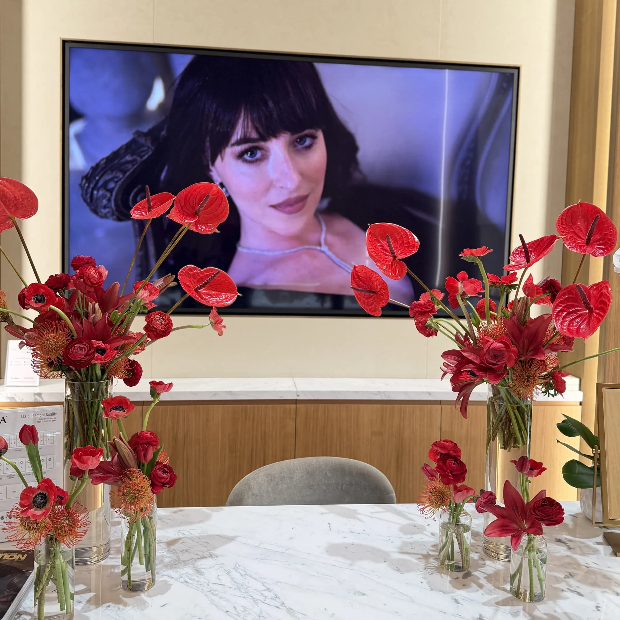 Red anthurium installation framing a screen at a brand event