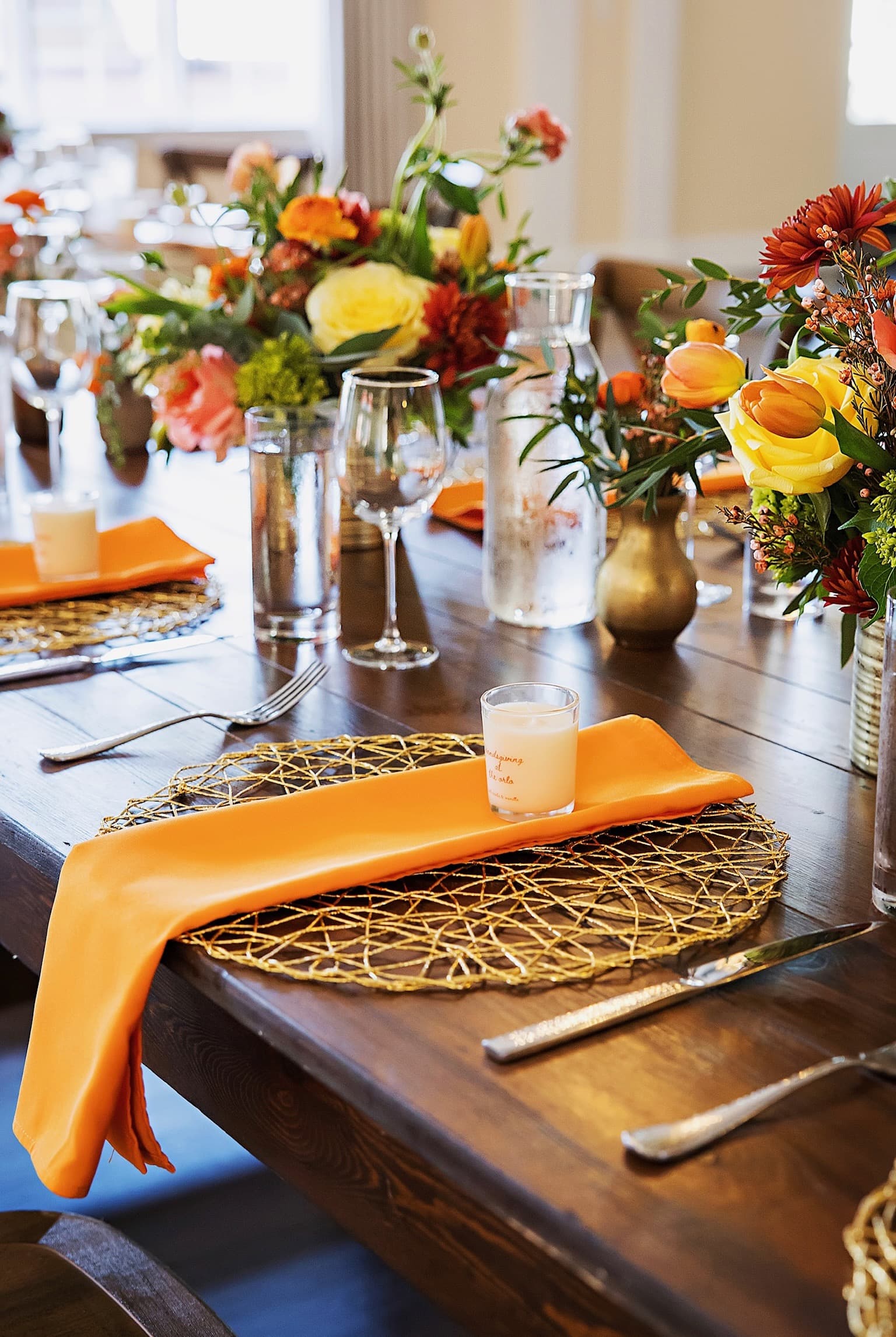 Autumn tablescape with marigold napkins and low centerpieces